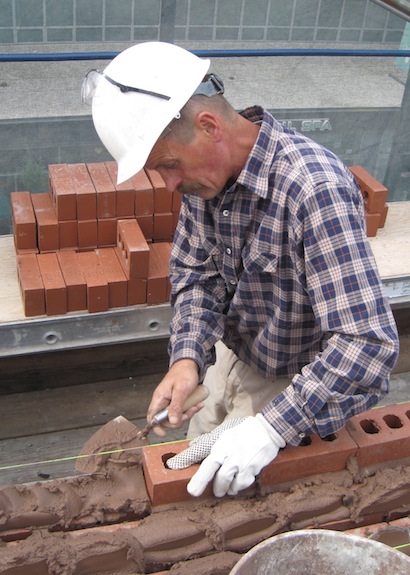 AAA-1 licensed mason Bogdan laying bricks