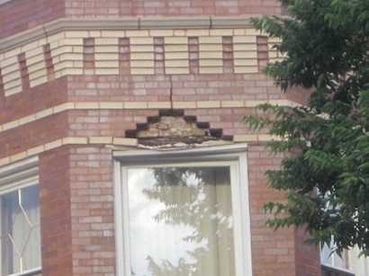 Bricks and mortar in excess of 100 pounds fell out of this third-story window head