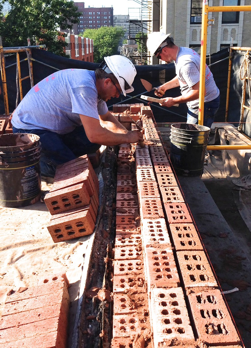 Adam and Johnny of AAA-1 rebuilding a parapet wall in Hyde Park.