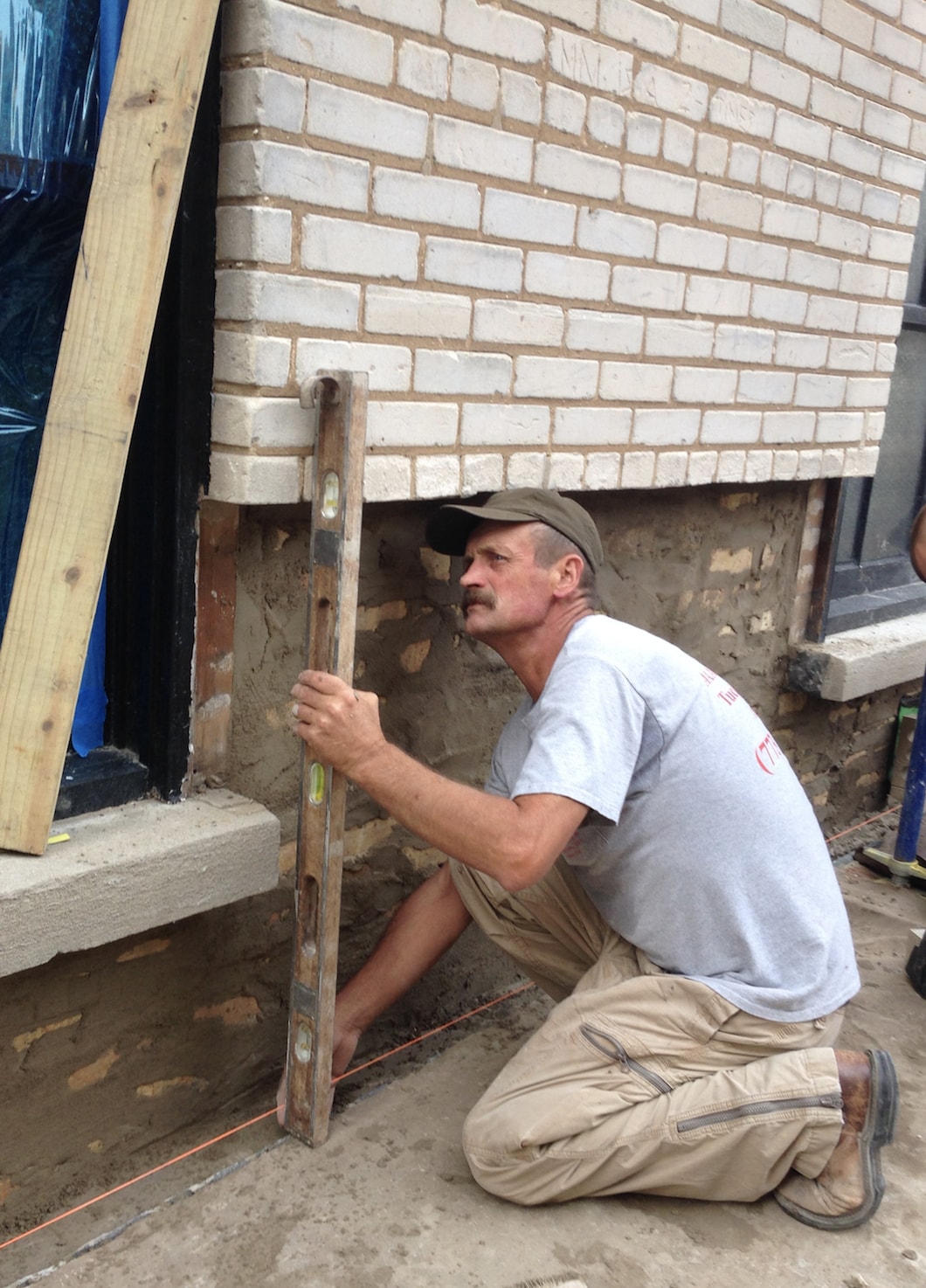 A licensed mason checking for plumb and level