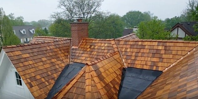 A view of the completed chimney, with new concrete cap and copper flashing