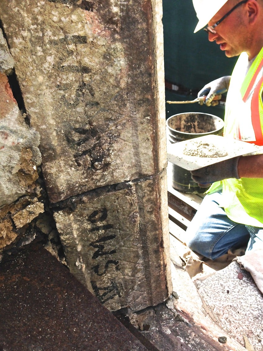 Adam about to start tuckpointing a portion of the 100-year-old terra cotta parapet wall.