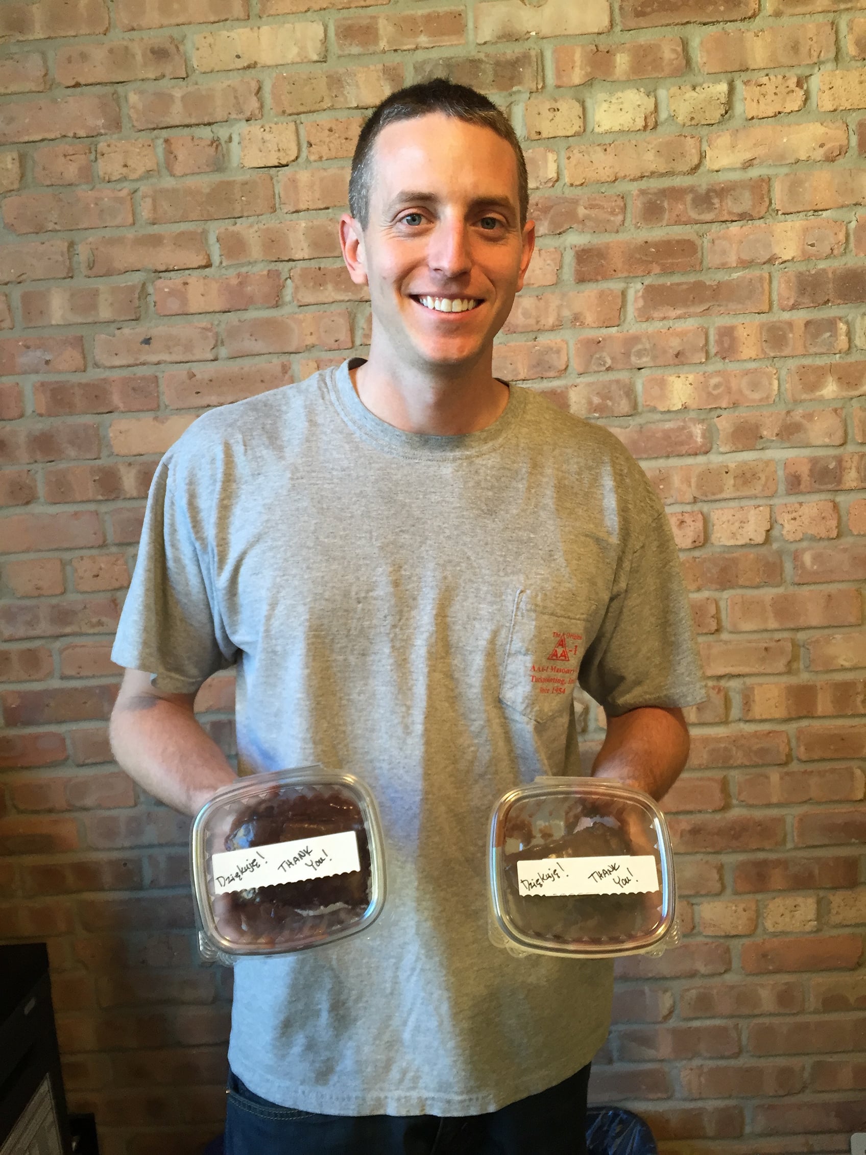 AAA-1 project manager Dan Kruk holding cookies baked for our masons by a happy client.