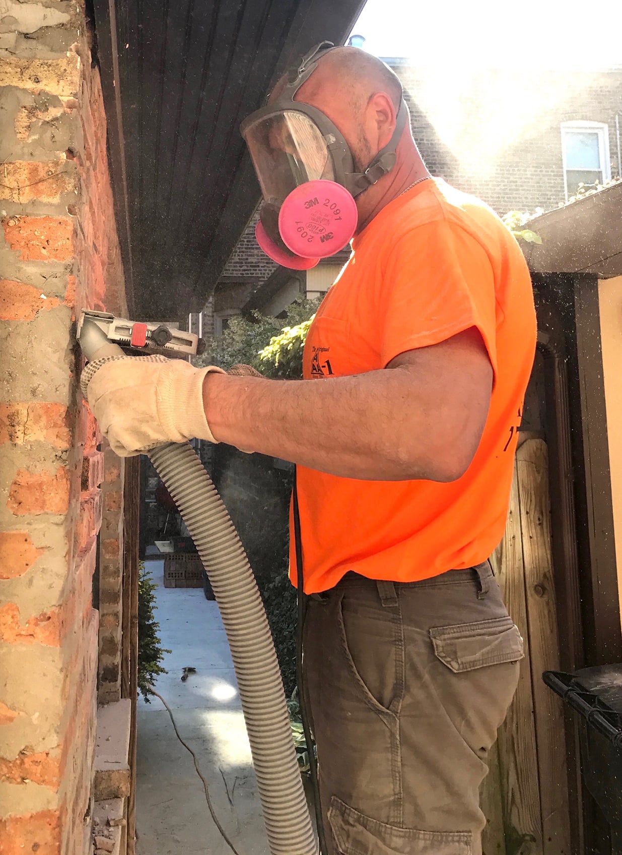 Andrew, an AAA-1 licensed mason, grinding a defective mortar joint