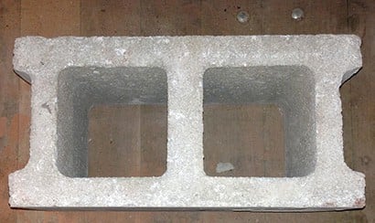 A hollow concrete / split face block