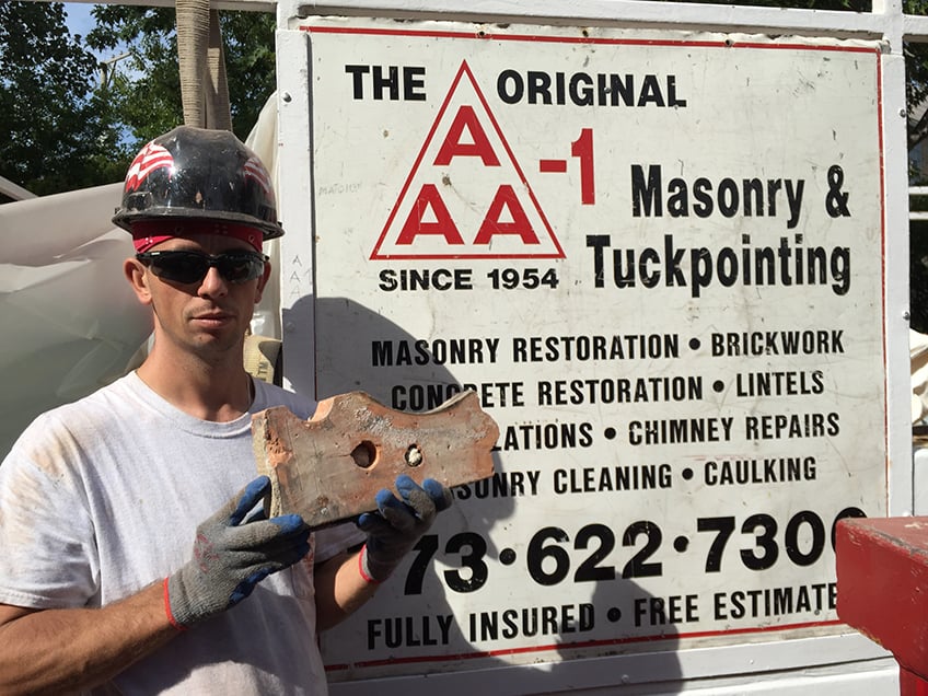 Kamil holding up an unusual brick