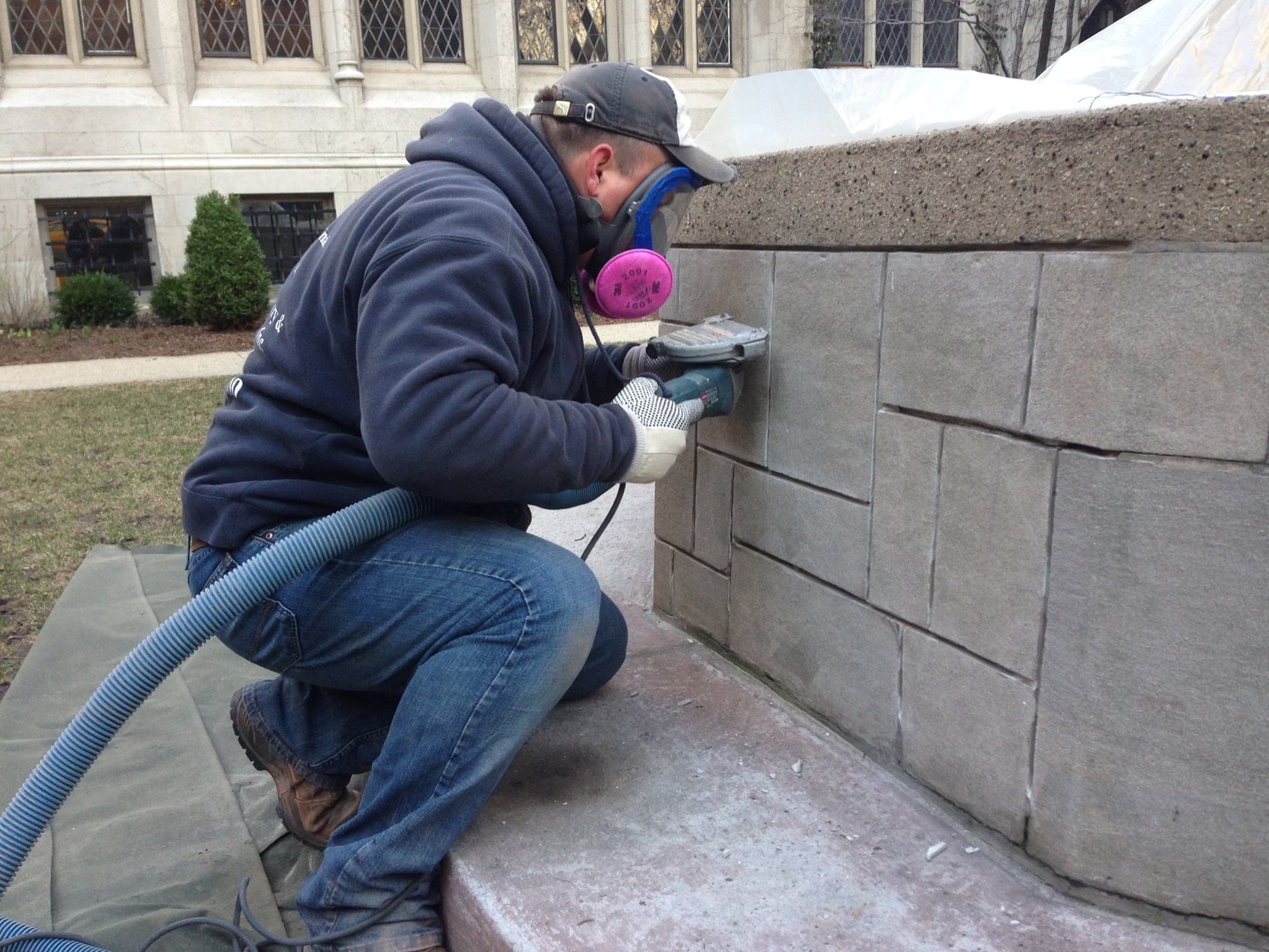 An AAA-1 licensed mason grinding a defective mortar joint