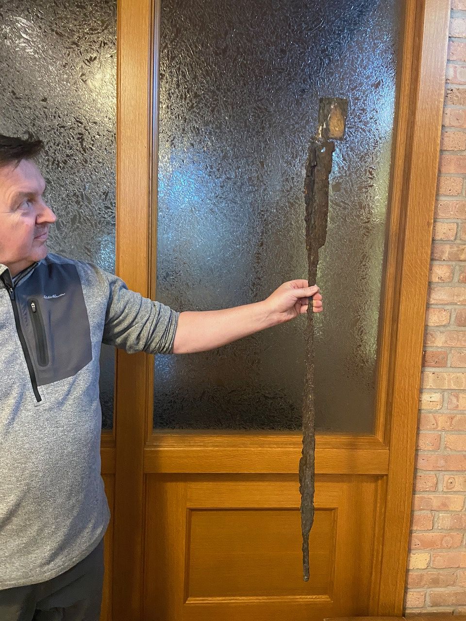 Andy holding a severely rusted steel lintel